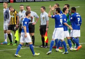 The teams make their way on to the pitch