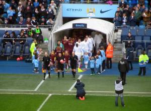 The players appear from the tunnel