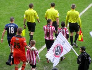 The players make their way on to the pitch