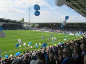 Balloons are released as the players head out of the tunnel
