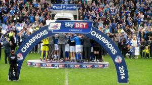 The trophy is lifted by Ian Evatt