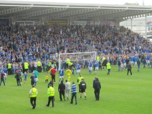 The players head past the Kop