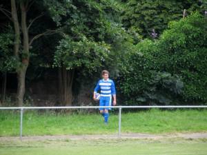 A Hallam player retrieves the ball from the trees!