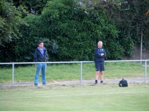 Physio Jamie Hewitt watches alongside a supporter