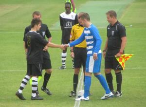 The captains exchange handshakes