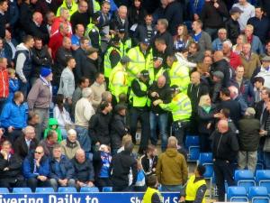 Some United fans in the home end are escorted away