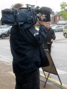 A cameraman films their arrival