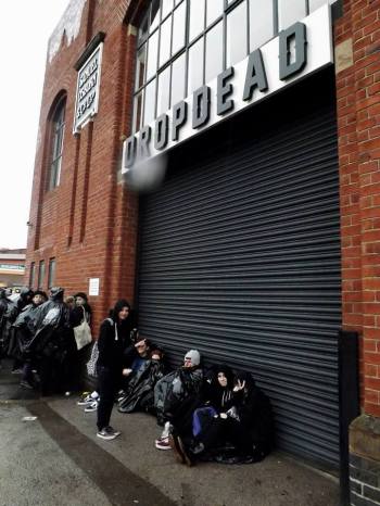 Fans wait in the pouring rain!