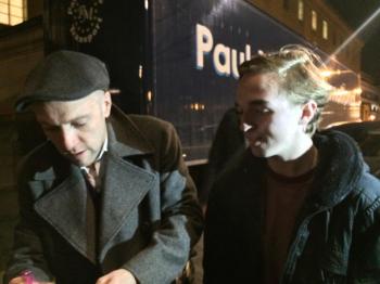 I look on as he signs an autograph